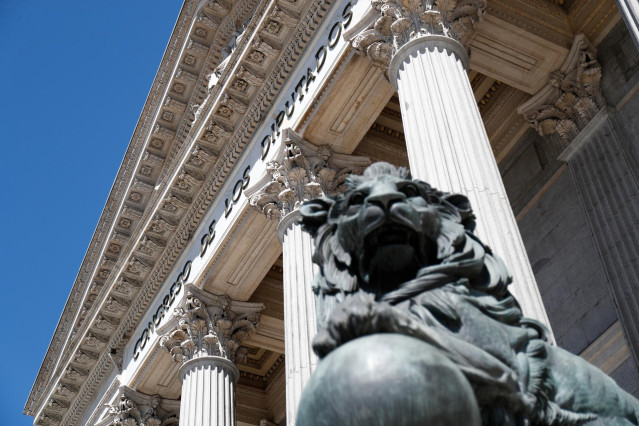 Uno de los emblemáticos leones que se encuentran delante de la fachada del Congreso de los Diputados en la Plaza de las Cortes de Madrid.