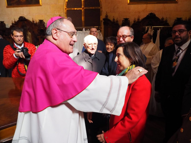 El obispo de Ávila saluda a la ministra de Defensa en funciones.