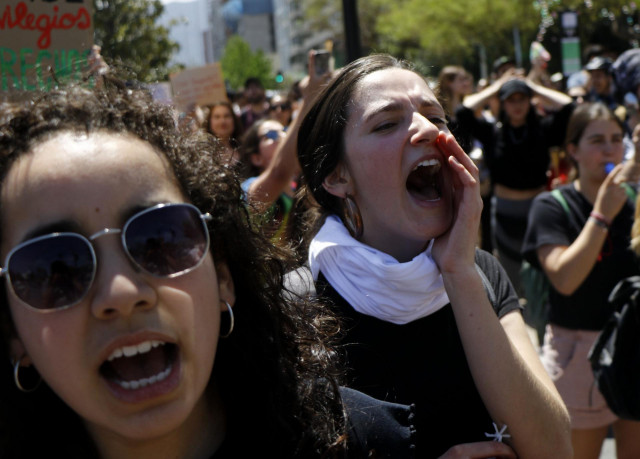 22 October 2019, Chile, Santiago: Demonstrators shout slogans during a protest. The demonstrations were unleashed when the government decided to increase the metro ticket and triggered economic unrest in various sectors. So far, 15 people have been offici