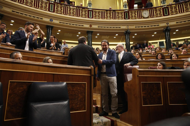 El portavoz de ERC en el Congreso de los Diputados, Gabril Rufián (i), aplaude el saludo del secretario general de Podemos, Pablo Iglesias (d)