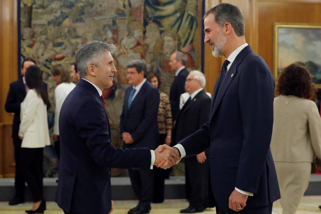 El ministro de Interior, Fernando Grande-Marlaska (izq), saluda al Rey Felipe VI (dech), tras jurar su cargo en el Palacio de la Zarzuela de Madrid, a 13 de enero de 2020.