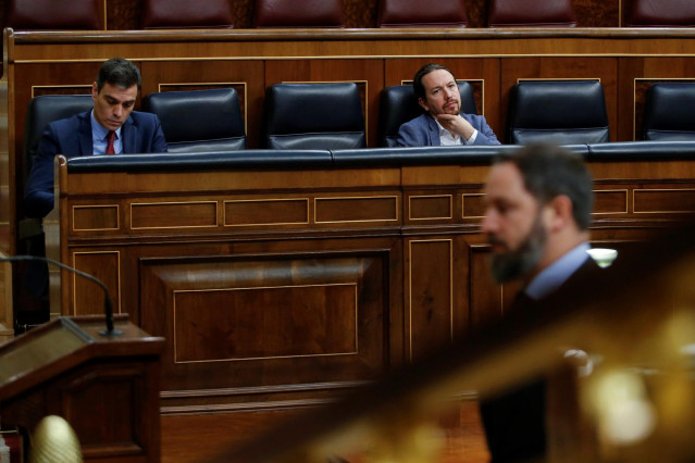El presidente del Gobierno, Pedro Sánchez, y el vicepresidente Pablo Iglesias viendo pasar en el Congreso a Santiago Abascal.