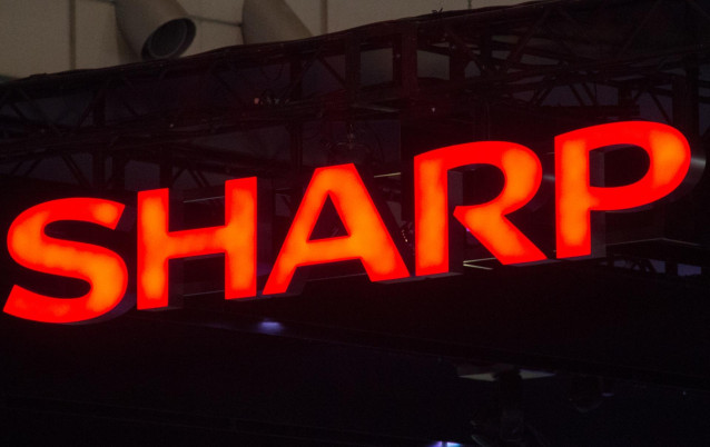 FILED - 04 October 2012, Japan, Chiba: A general view of the logo of Japanese electronics company Sharp at the Ceatec trade fair. Sharp lowered its forecast for sales for the current fiscal year ending 31 March 2020 due to the slow recovery in demand for