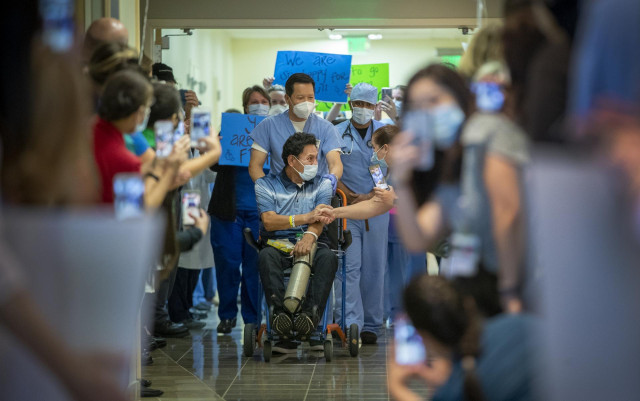 May 5, 2020 - Orange, California, United States: Armando Mendoza, 53, of Anaheim, who was the hospital's second-ever COVID-19 patient, spent 45 days at St. Joseph Hospital, the longest local stint of any COVID-19 patients, is congratulated by a health-car