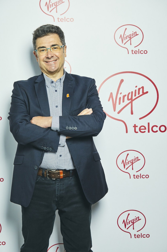 Jose Miguel García, consejero delegado del Grupo Euskaltel, con el logo de Virgin Telco