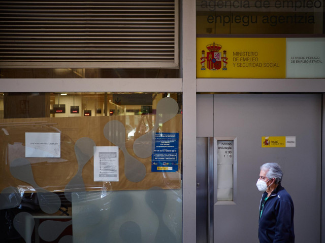 Un hombre pasa frente a una oficina de empleo