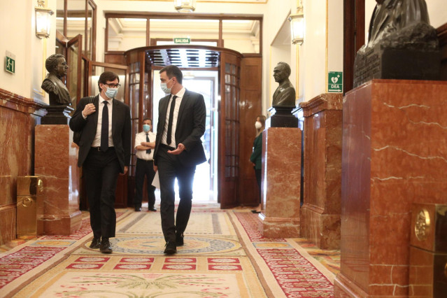 El presidente del Gobierno, Pedro Sánchez (d), llega con el ministro de Sanidad, Salvador Illa, al pleno de sesión de control al Gobierno centrado en las medidas post-COVID 19