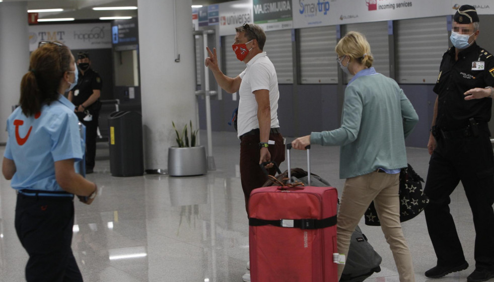Dos viajeros procedentes de Alemania llegan al Aeropuerto de Palma de Mallorca el día en el que arranca en Baleares el plan piloto