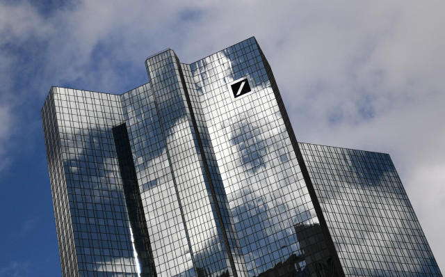 FILED - 04 March 2019, Hessen, Frankfurt_Main: Clouds pass over the Deutsche Bank headquarters in Frankfurt's banking district. After no dividends were paid out in 2019, Deutsche Bank shareholders were told on Wednesday that they will have to wait another