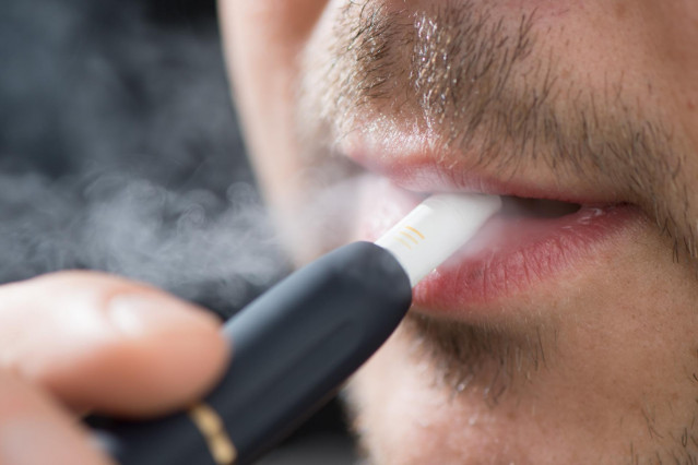 FILED - 31 May 2019, Saxony, Dresden: A man smokes with the electronic tobacco heater IQOS (I quit ordinary smoking). China plans to ban electronic cigarette smoking in public places to stop the increase in the use of cigarettes among teenagers. Photo: Se