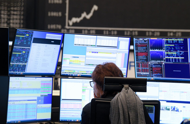 09 March 2020, Hessen, Frankfurt/Main: A stock trader watches her monitors on the trading floor of the Frankfurt Stock Exchange. Stock exchanges around the world are reacting with huge losses to the fall in oil prices and concerns about the economic conse