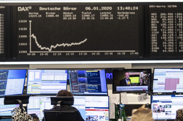 06 January 2020, Hessen, Frankfurt_Main: A stock trader works on the Frankfurt Stock Exchange, as the conflict between the USA and Iran has further unsettled investors in the German stock market. The Dax temporarily slipped below the 13,000 mark, a low fo