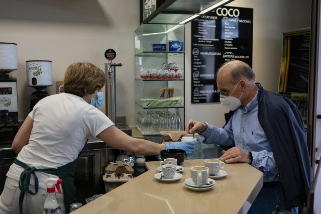 Un hombre toma un café en un bar de la capital de A Coruña, el día que en el que la provincia pasa junto al resto de las que componen Galicia -Pontevedra, A Coruña y Ourense- a la Fase 1 del Plan de Desescalada establecido por el Gobierno de España.  En A