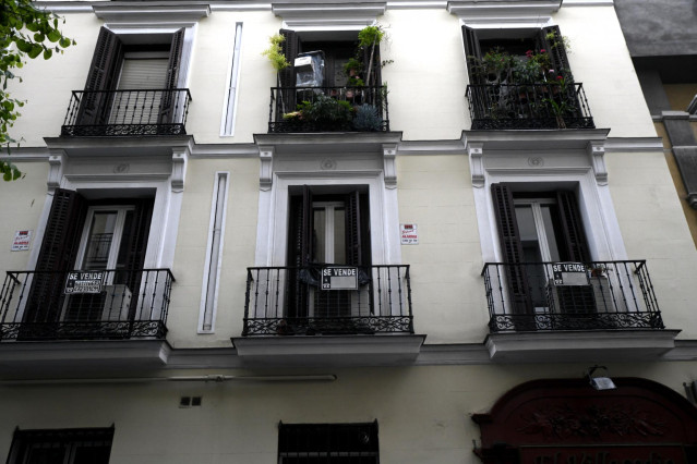 Cartel colgado en un edificio que indica que el inmueble está en venta.