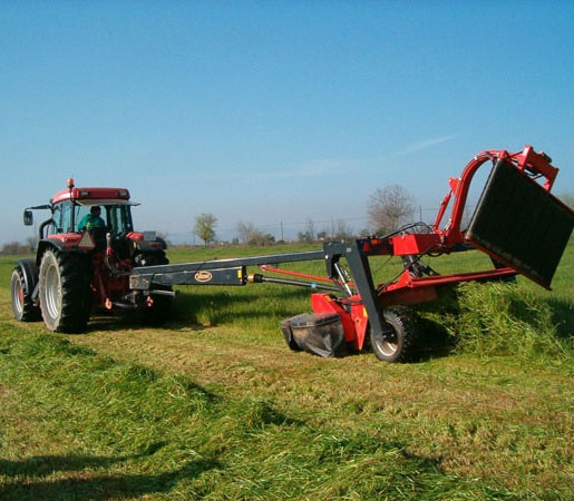 Un tractor trabaja con maquinaria agrícola en el campo.