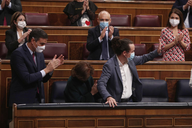 El presidente del Gobierno, Pedro Sánchez (i), acompañado de otros miembros del partido aplauden al vicepresidente segundo del Gobierno, Pablo Iglesias (c), tras su intervención en la segunda sesión del pleno en el que se debate la moción de censura plant