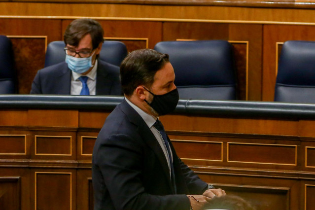 El líder de Vox, Santiago Abascal, pasa por delante del ministro de Sanidad, Salvador Illa,