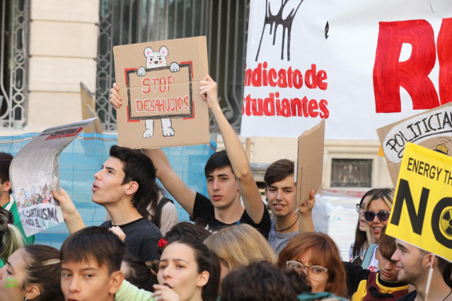 Un chico sujeta un cartel en el que se lee `Stop desahucios´ durante la manifestación del Sindicato de Estudiantes por la Huelga Mundial por el Clima, en la Puerta del Sol, en Madrid, a 27 de septiembre de 2019.