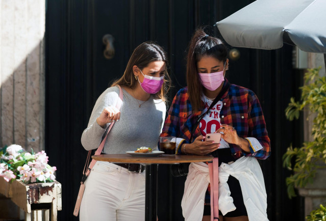 Consumidores de terrazas, bares y cafeterías con mascarillas