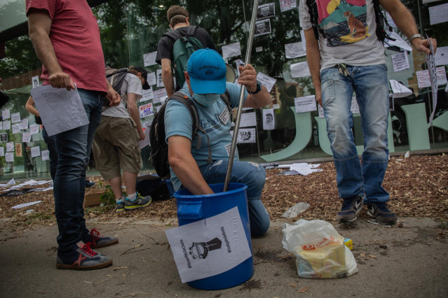 Varios trabajadores de Nissan cuelgan carteles como signo de protesta por el cierre de las fábricas de Barcelona.