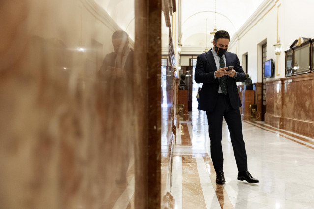 El presidente de Vox, Santiago Abascal, consulta su teléfono móvil