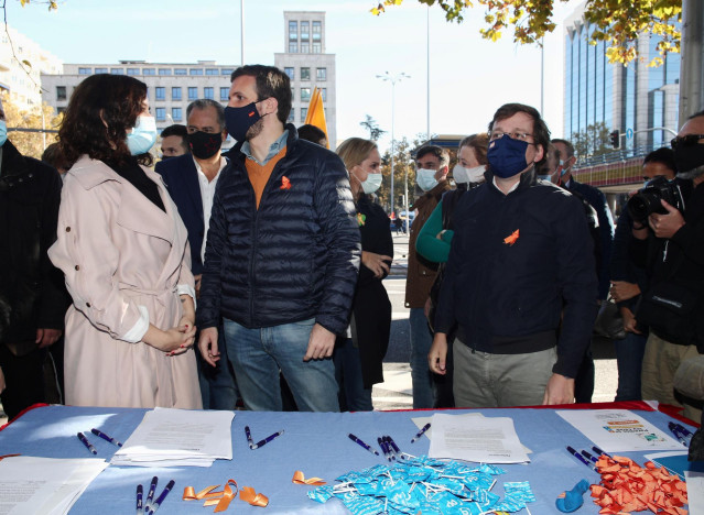 El presidente del Partido Popular, Pablo Casado, la presidenta de la Comunidad de Madrid, Isabel Díaz Ayuso, y el alcalde de Madrid, José Luis Martínez-Almeida, participan en una recogida de firmas en la caseta instalada por el PP en una manifestación de