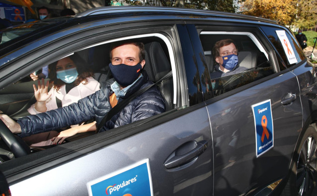 El presidente del PP, Pablo Casado, conduce un coche acompañado de la presidenta de la Comunidad de Madrid, Isabel Díaz Ayuso, y el alcalde de Madrid, José Luis Martínez-Almeida, durante una manifestación de vehículos contra la Ley Celaá