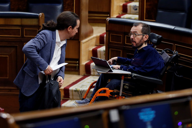El vicepresidente segundo del Gobierno, Pablo Iglesias (i), conversa con el diputado de Unidas Podemos, Pablo Echenique (d), en el Congreso. En Madrid, (España), a 9 de abril de 2020.