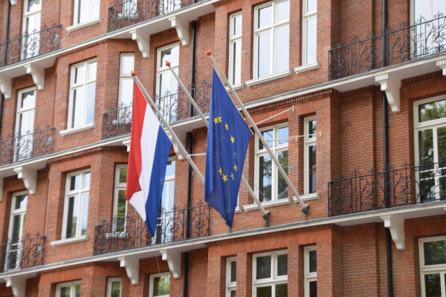 Las banderas de Países Bajos y la Unión Europea en un edificio oficial