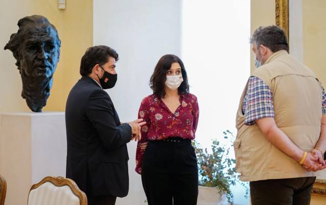 La presidenta de la Comunidad de Madrid en funciones, Isabel Díaz Ayuso, junto con el consejero de Vivienda, David Pérez, y con el presidente de la Plataforma de Feriantes de la Comunidad de Madrid, Pedro Gorrochategui, en la Real Casa de Correos