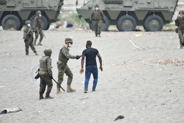 Militares del ejército español efectúan una devolución en caliente a uno de los migrantes que han entrado en Ceuta procedente de Marruecos, a 18 de mayo de 2021, en Ceuta, (España). Al menos 2.700 personas han sido devueltas a Marruecos en las últimas hor
