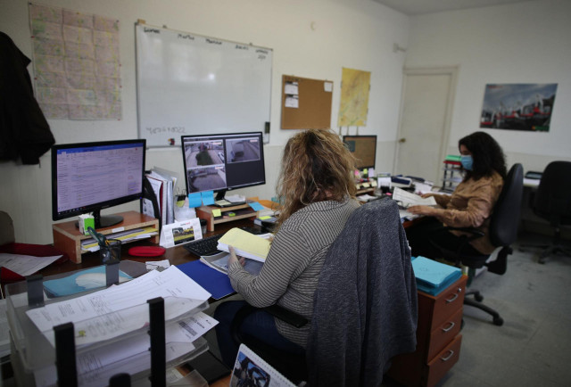 Archivo - Dos operarias protegidas con mascarillas trabajan desde el ordenador