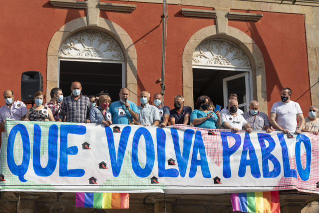 Un grupo de personas sostiene una pancarta en una concentración por la 