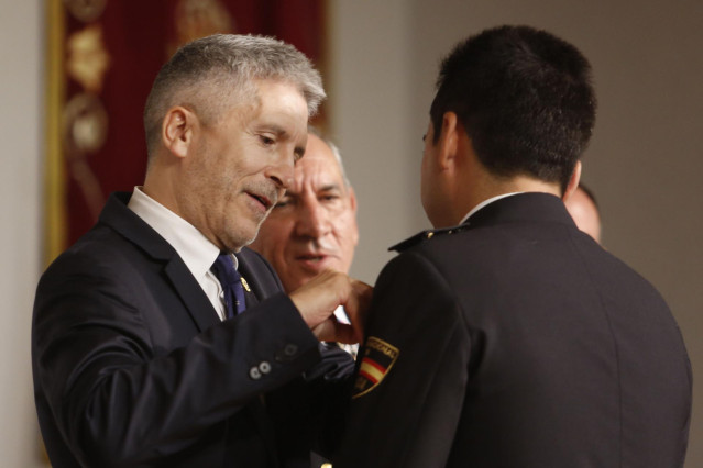 Archivo - El ministro del Interior en funciones, Fernando Grande-Marlaska, entrega medalla al mérito a un policía en 2019.