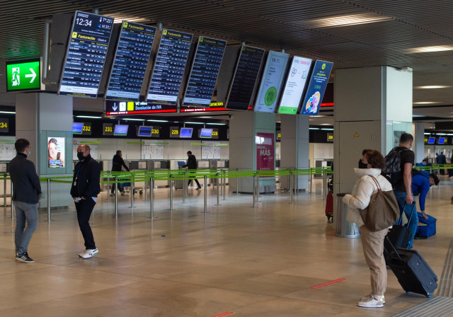 Archivo - Varias personas con maletas en la Terminal 1 del Aeropuerto Adolfo Suárez Madrid Barajas, en Madrid (España).