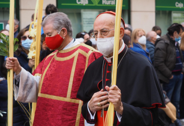 Archivo - El Cardenal Arzobispo, Ricardo Blázquez (d), durante la procesión de Las Palmas, desde unos balcones, a 10 de abril de 2022, en Valladolid, Castilla y León (España).