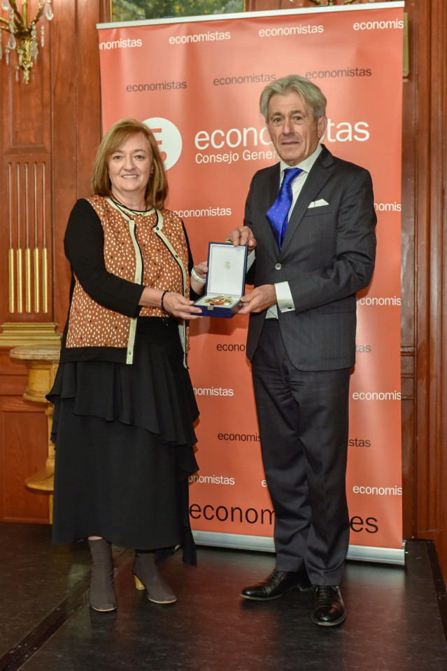Momento de la entrega de la Gran Cruz al Mérito en el Servicio de la Economía 2022 a Cristina Herrero, presidenta de la AIReF, de manos del presidente del Consejo General de Economistas, Valentín Pich.