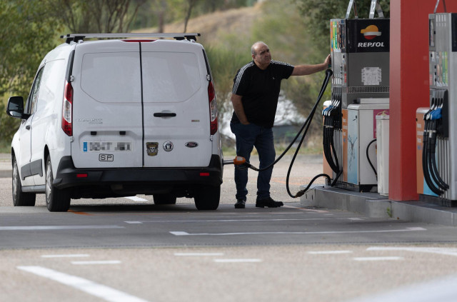Una persona reposta su vehículo en una gasolinera