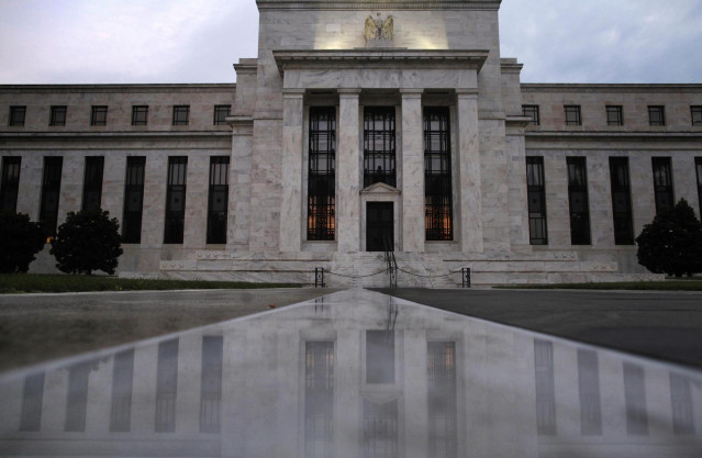 Archivo - La entrada del edificio de la Reserva Federal de Estados Unidos reflejada en mármol húmedo en una mañana en Washington, jul 31 2013. La Reserva Federal de Estados Unidos iniciaría el miércoles su larga salida de una política monetaria ultra flex