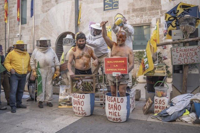 Varios apicultores echan miel a otros durante una concentración de las organizaciones profesionales agrarias y entidades relacionadas con el sector apícola de la Comunitat Valenciana, ante las puertas de Les Corts, a 2 de febrero de 2023, en Valencia