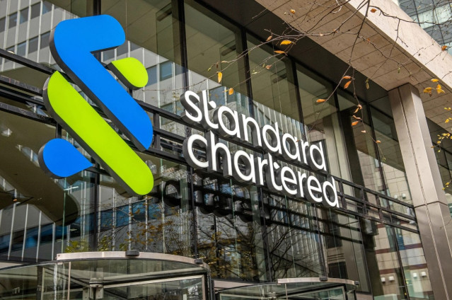 Archivo - Logo de Standard Chartered en una oficina
