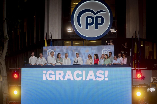 El candidato del PP a la Presidencia del Gobierno de España, Alberto Núñez Feijóo (c), durante el seguimiento de la jornada electoral