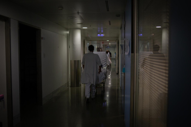Archivo - Profesional sanitario traslada una cama m&oacute;vil en la Unidad de Cuidados Intensivos &ndash;UCI- del Hospital de la Santa Creu i Sant Pau, integrado en la Red Hospitalaria de Utilizaci&oacute;n P&uacute;blica de Catalunya, en Barcelona, Catalunya (Espa&ntilde;a), a 6 de novi