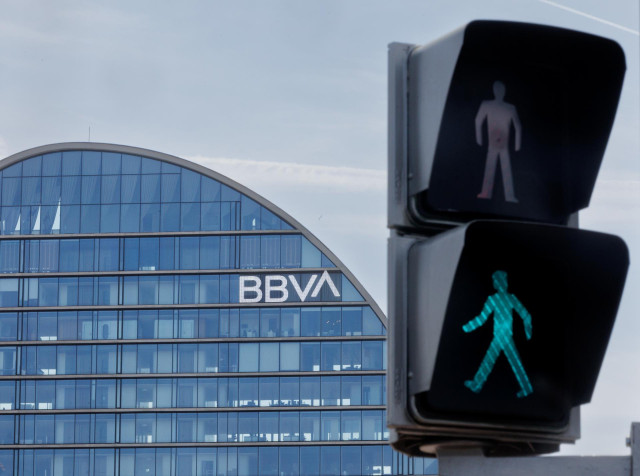 Archivo - Un semáforo frente al banco del BBVA en la ciudad del BBVA, a 10 de abril de 2023, en Madrid (España).