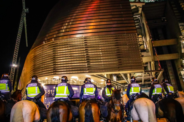 Archivo - Agentes de policía escoltan a los aficionados en las inmediaciones del estadio Santiago Bernabéu