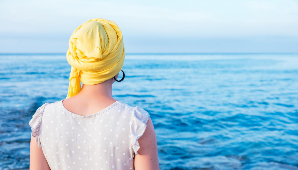 Female with yellow scarf enjoying sea view