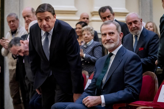 El Rey Felipe VI (d) y el ministro de Agricultura, Pesca y Alimentación, Luis Planas (i), al simposio “Conservando sabiduría, abriéndose al futuro” del Colegio Libre de Eméritos Universitarios, en la Real Academia de Bellas Artes de San Fernando, a 20 de