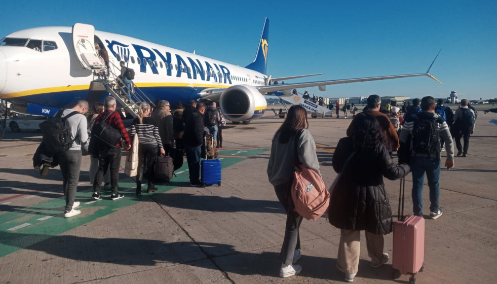 Archivo - Pasajeros de un vuelo de Ryanair suben a bordo de un avión estacionado en el aeropuerto de Sevilla.