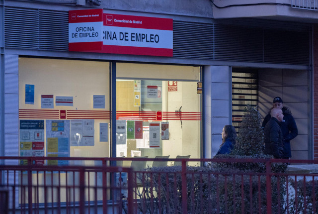 Archivo - Varias personas en la puerta de una oficina del SEPE.