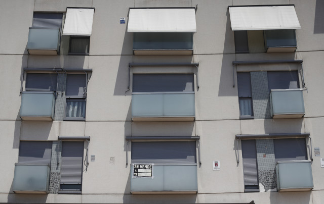 Archivo - Cartel de 'se vende' en el balcón de un piso de un edificio de Madrid.